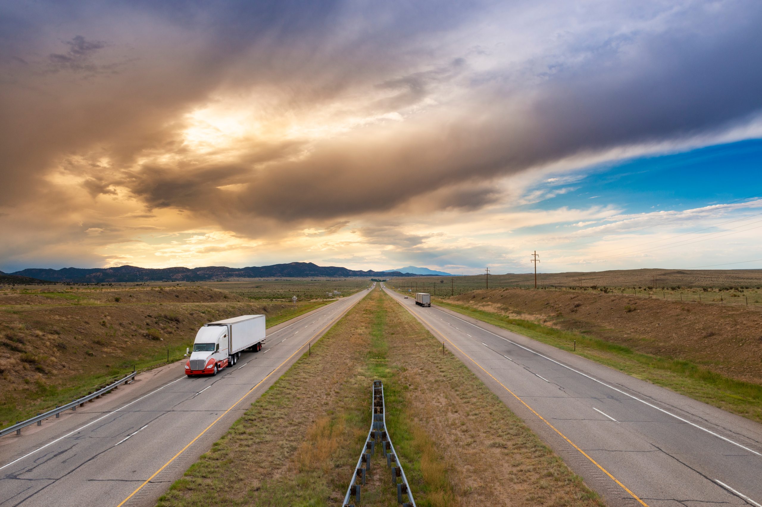 A semi truck at the I 25 interstate highway, in the State of Colorado, USA; Concept for freight transportation.<br />
